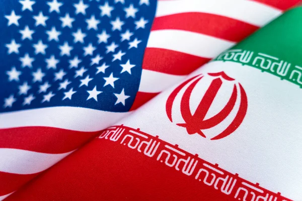 Background of the flags of the USA and iran. The concept of interaction or counteraction between the two countries. International relations. political negotiations. Sports competition.