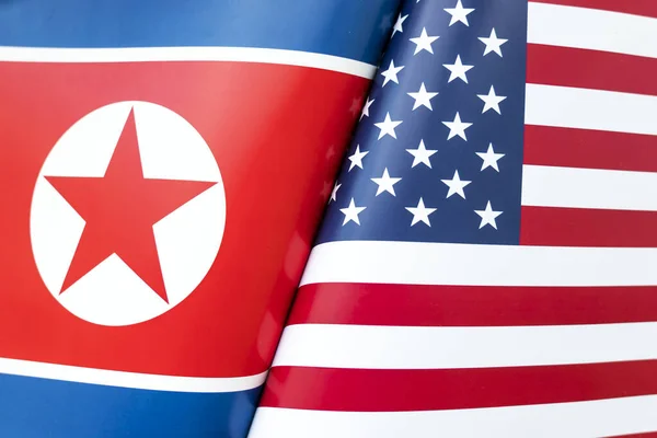 Background of the flags of the north korea and USA. The concept of interaction or counteraction between the two countries. International relations. political negotiations. Sports competition.