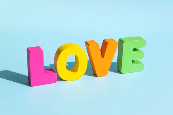 stock image multicolored letters forming word LOVE written on blue background