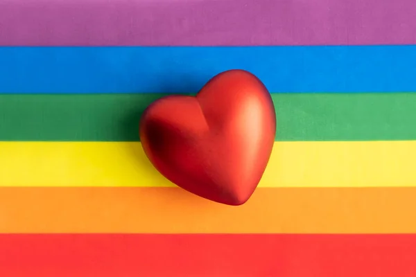 stock image the heart is red on the background of a rainbow flag.