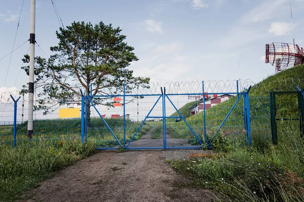 stock image The restricted area is fenced with a metal fence, gates and barbed wire.