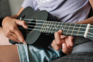 Ukulele çalan küçük kız. Sanat ve müzik kavramı. Eline odaklan..