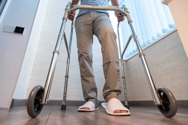 a sick person moves with the help of special walkers. Problems with the musculoskeletal system. The concept of rehabilitation. Restorative procedures.