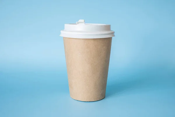 stock image brown paper coffee mug on a blue background. Empty space for text and design on a cup of coffee. form for the name of the coffee or company or coffee shop