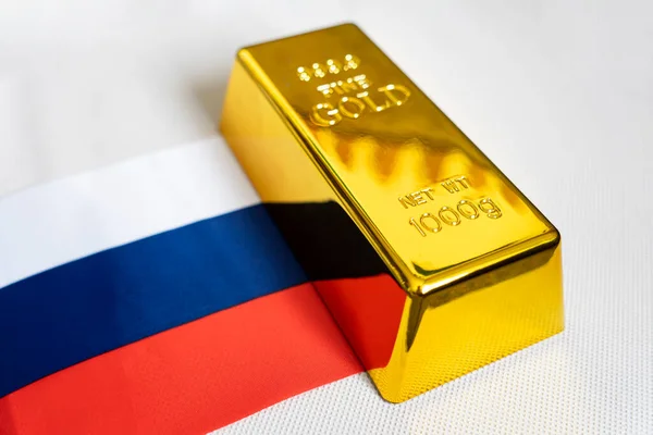 stock image The gold bar is on the national flag of russia. russian Gold Reserve concept