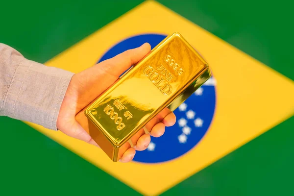 Gold Reserve Brazil Concept Gold Bar Hand Brazilian Flag Background — Stock Photo, Image