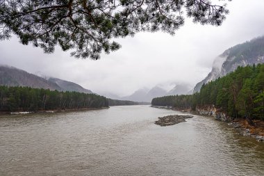 View from the bank of the Katun River to the island of Patmos with the hermitage of the Orthodox monastery, Gorny Altai