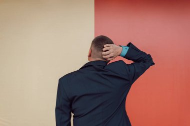 Genç ve yakışıklı bir adam bilgisiz ve kafası karışık hissediyor, bir çözüm düşünüyor, elleri başının üstünde, dikiz aynasıyla. metin için boşluk kopyala. Seçim konsepti. iki seçenek var.
