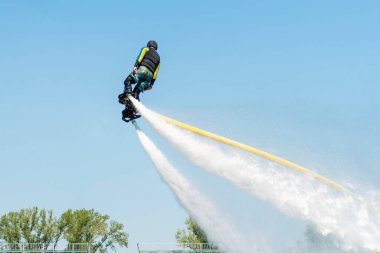 Fly board show at the port. Extreme sport clipart