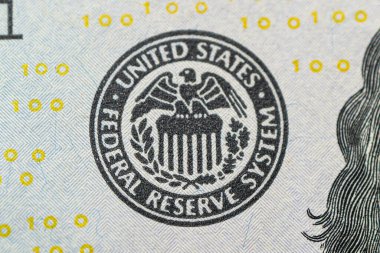 Federal Reserve System logo close-up. US Federal Reserve emblem on hundred dollars banknote as FED consider interest rate hike, economics, inflation control national organization. clipart
