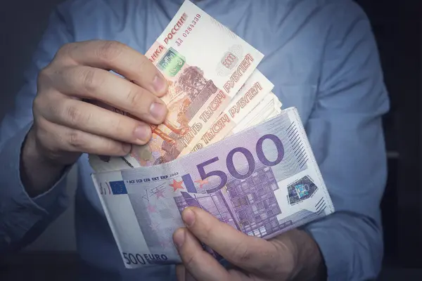 stock image Hands take out russian rubles from wallet. Closeup on a man's hands as he is getting a banknote out of his wallet. a lot of money. a rich man. income from trading on the stock exchange concept