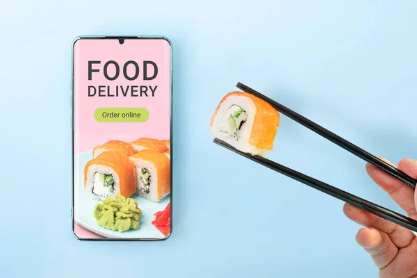 Order sushi set using mobile phone app. Online food delivery concept. order a meal in a restaurant using the app on your mobile phone.