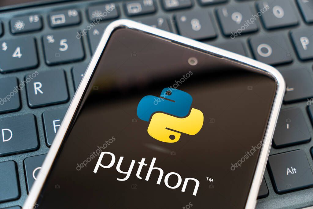 Programming language for mobile development, concept. Smartphone on the laptop keyboard. logo python on the mobile phone screen. Barnaul. Russia March 28, 2023.