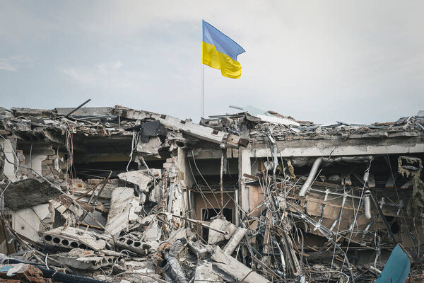 destroyed building. view of the ruins. the wreckage of the building and the Ukrainian flag