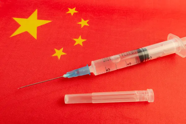 Vaccine, syringes and Chinese flag. Microbiological research in China. Development of antiviral drugs in the Republic of China. bottle covid-19 vaccine. Sinovac new china vaccine.