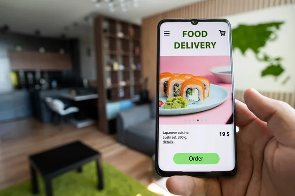 Order and deliver food online. Eat from smartphone. Gadget on blue background. fast food and fast delivery when ordering online concept. order a meal in a restaurant using the app on mobile phone