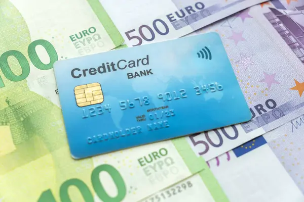 money and credit cards. the blue credit card is on cash euros. multi-currency account in different currencies concept.