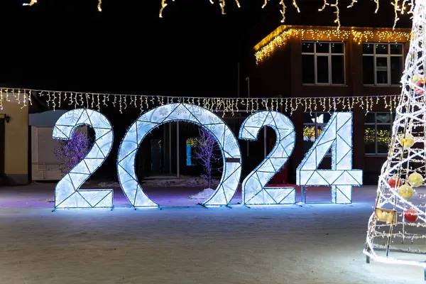 2023 figures on snow on a dark night background. Decorative figures decorate the city square for the celebration of the new year.