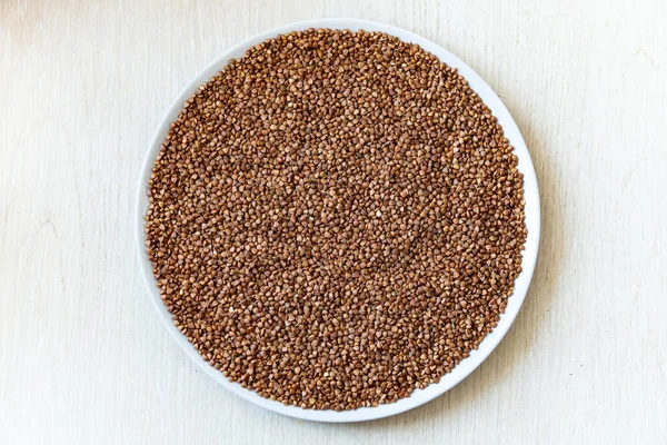 top view buckwheat grain in bowl on white background,