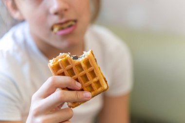 Tanınmayan bir kadının ısırık waffle 'ını kapat. Tatlı tatlı.