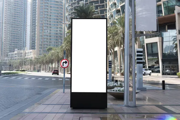 Blank mock up of vertical street poster billboard on city background. Electronic modern empty scoreboard on the background of a city street. copy space