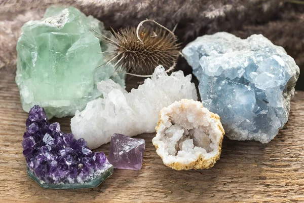 Group of Raw Natural Mineral Stones and Crystals. Green Fluorite, Blue Celestine, Clear Quartz Geode and Amethyst Cluster