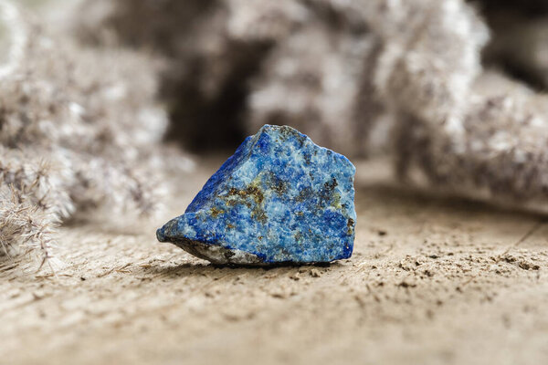 Piece of Raw Uncut, Blue Lazurite Mineral Stone Specimen on Wooden Background