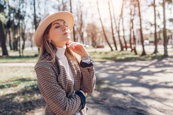 Stock image Portrait of stylish young woman wearing hat, blazer walking in park. Spring female clothes and accessories. Fashion. Space