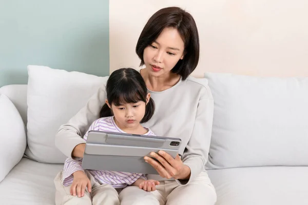 stock image Korean child and mom using tablet, online medical consultations concept