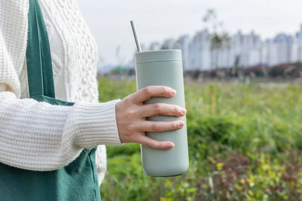 stock image eco friendly habit hand gesture, holding a tumbler