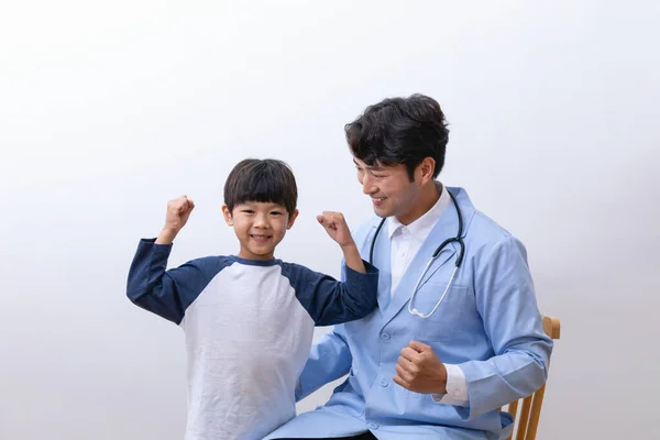 Asian Korean child and doctor doing hand motion