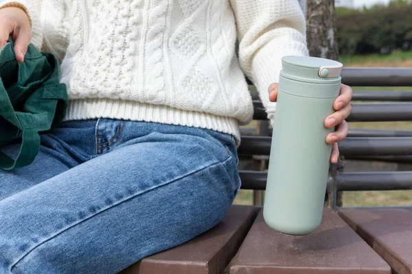 stock image eco friendly habits hand gesture, tumbler on the chair