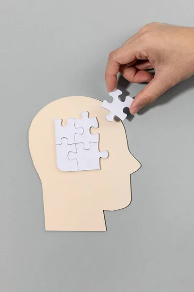 stock image brain health and dementia series, holding the puzzle