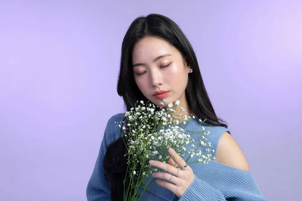 stock image beautiful young Korean Asian woman portrait studio photo in winter skin beauty and cosmetics concept, holding bay's breath