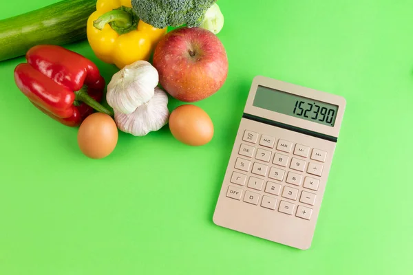 stock image conceptual creative photo of monetary inflation, economic recession, crisis, vegetables and calculator