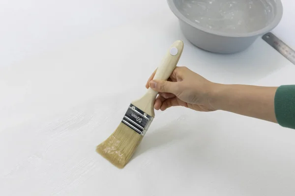 DIY interior hand motion, closeup, apply paste to wallpaper