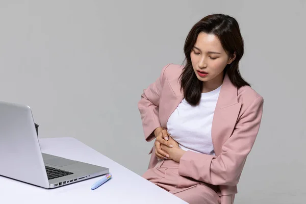 common health problems of office workers, korean young woman, stomachache