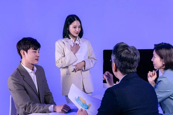 アジア系韓国人シニア 中高年 若い男性と女性の同僚モデルのビジネス服装 ネオンパープルのスタジオの背景 コンセプトを提示するのは難しい — ストック写真