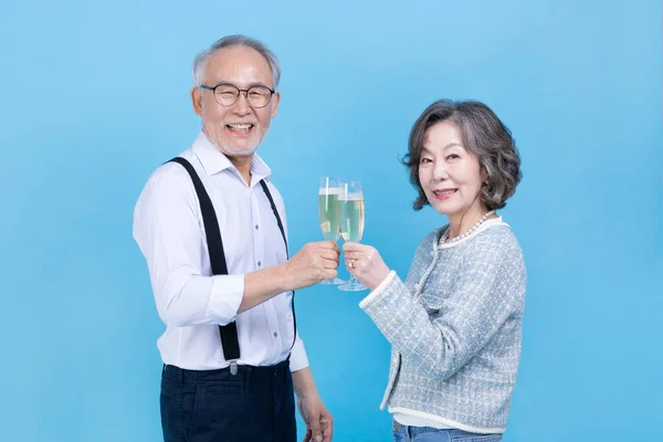 Active Young Senior Korean Asian Couple Holding Champagne Glasses Studio — Stock Photo, Image