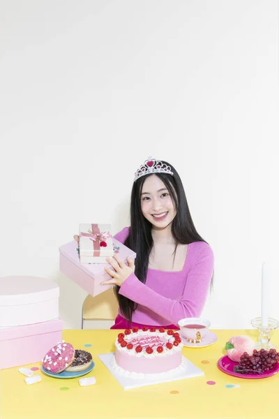 stock image vintage y2k pink retro concept photo of korean asian cute woman in birthday party concept against studio background