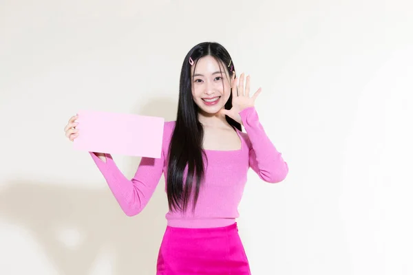 stock image vintage y2k pink retro concept photo of korean asian cute woman holding gift certificate coupon
