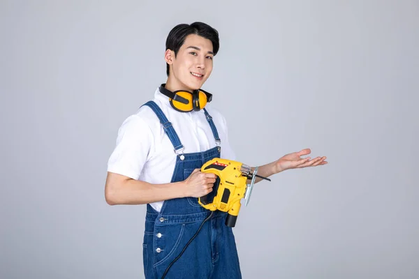 Millennials Gen Korean Asian Young Man Carpenter Holding Jigsaw — Stock Photo, Image