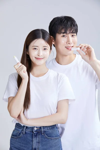 Korean Asian Young Couple Holding Lipbalm Studio Background — Stock Photo, Image