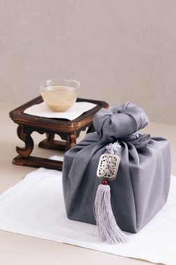 There is sikhye on the tea table and a gift cloth next to it clipart