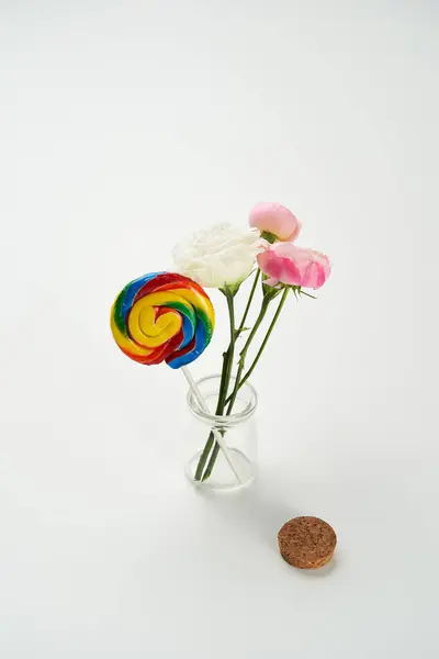 Lollipop candy and flowers are in vial