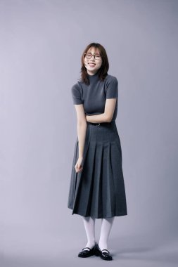 A Korean Woman in Her 20s Poses in a Neat Gray Costume With Glasses clipart