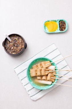 Odeng and odeng soup plated with a snack bar atmosphere clipart