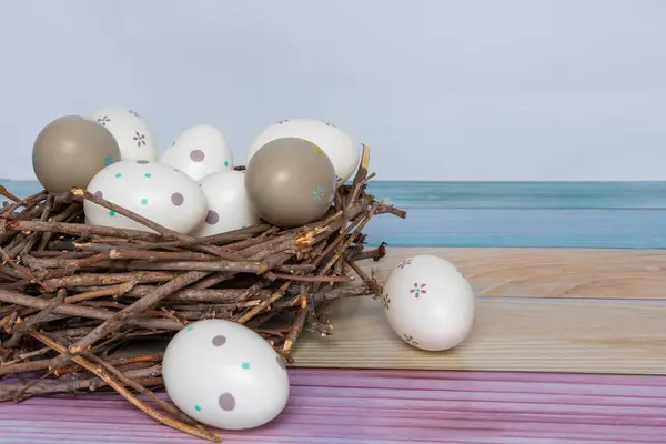 Painted Easter eggs in a nest of twigs.