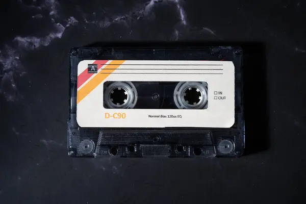 Colorful audio cassette on a dark background.