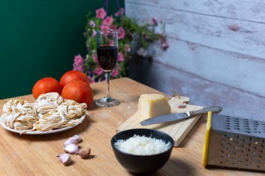 Yemek hazırlama: erişte, peynir, domates, sarımsak ve bir bardak şarap..